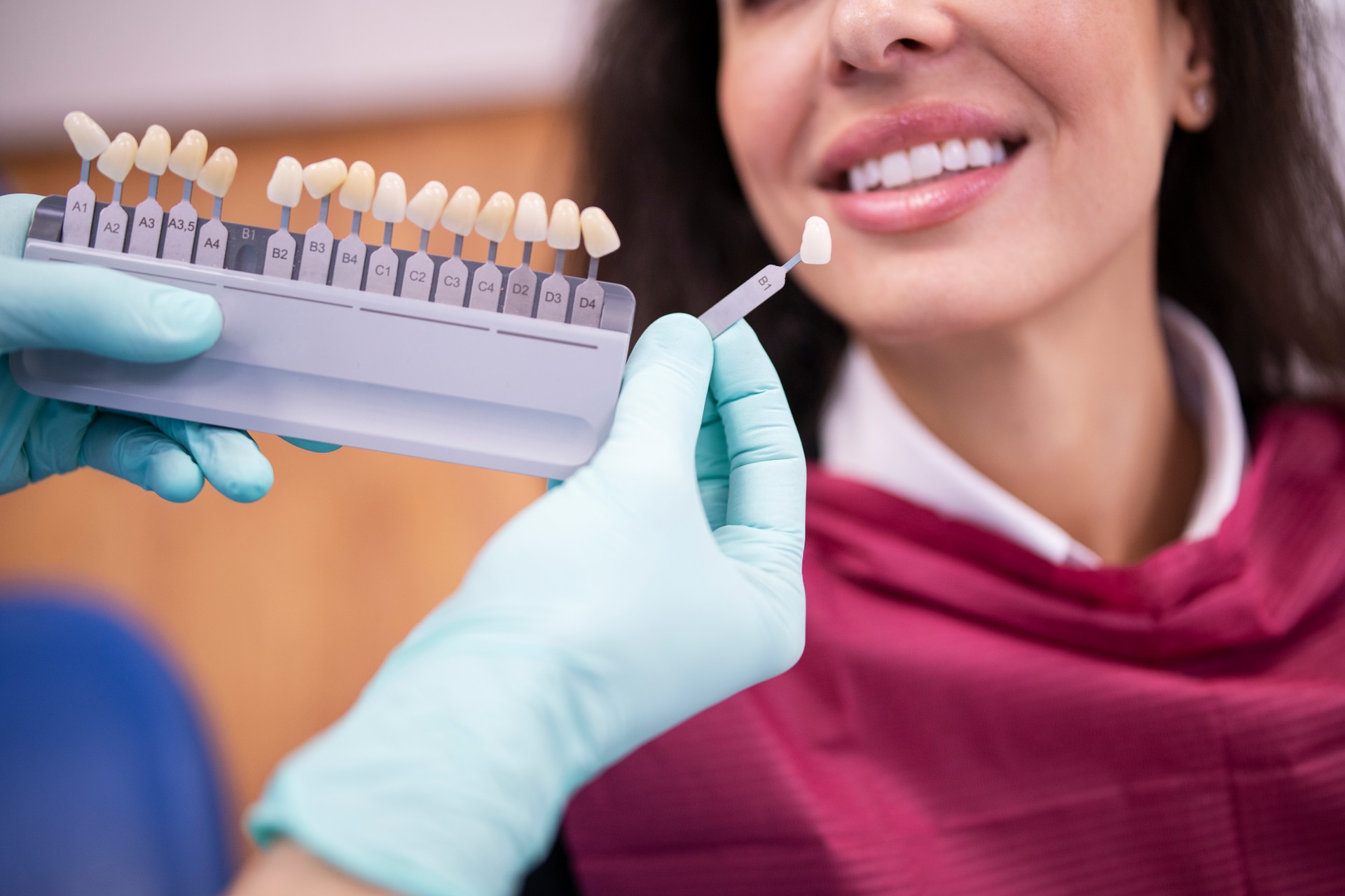 Dentist matching the right white tone for a dental crown.