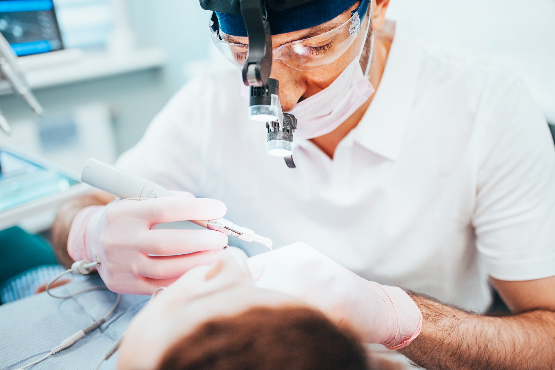 Dentist cleans tooth canals of patient and removes nerve